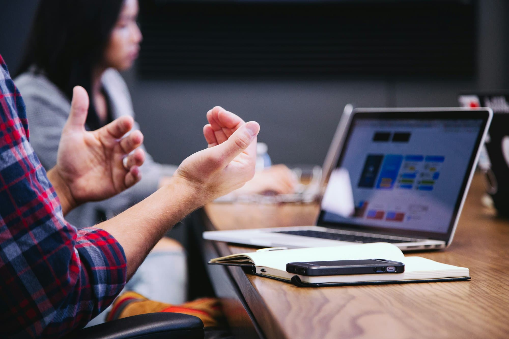 A working conversation at a table — growth is the work after the site exists