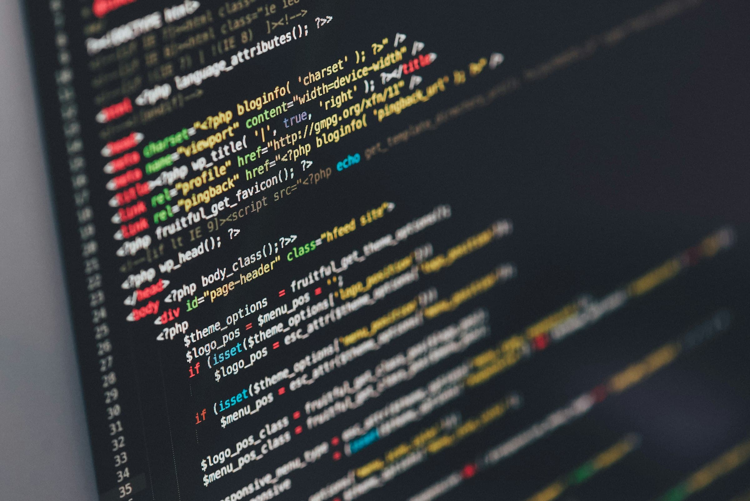 A monitor filled with code — the work happens in a window you cannot see the size of