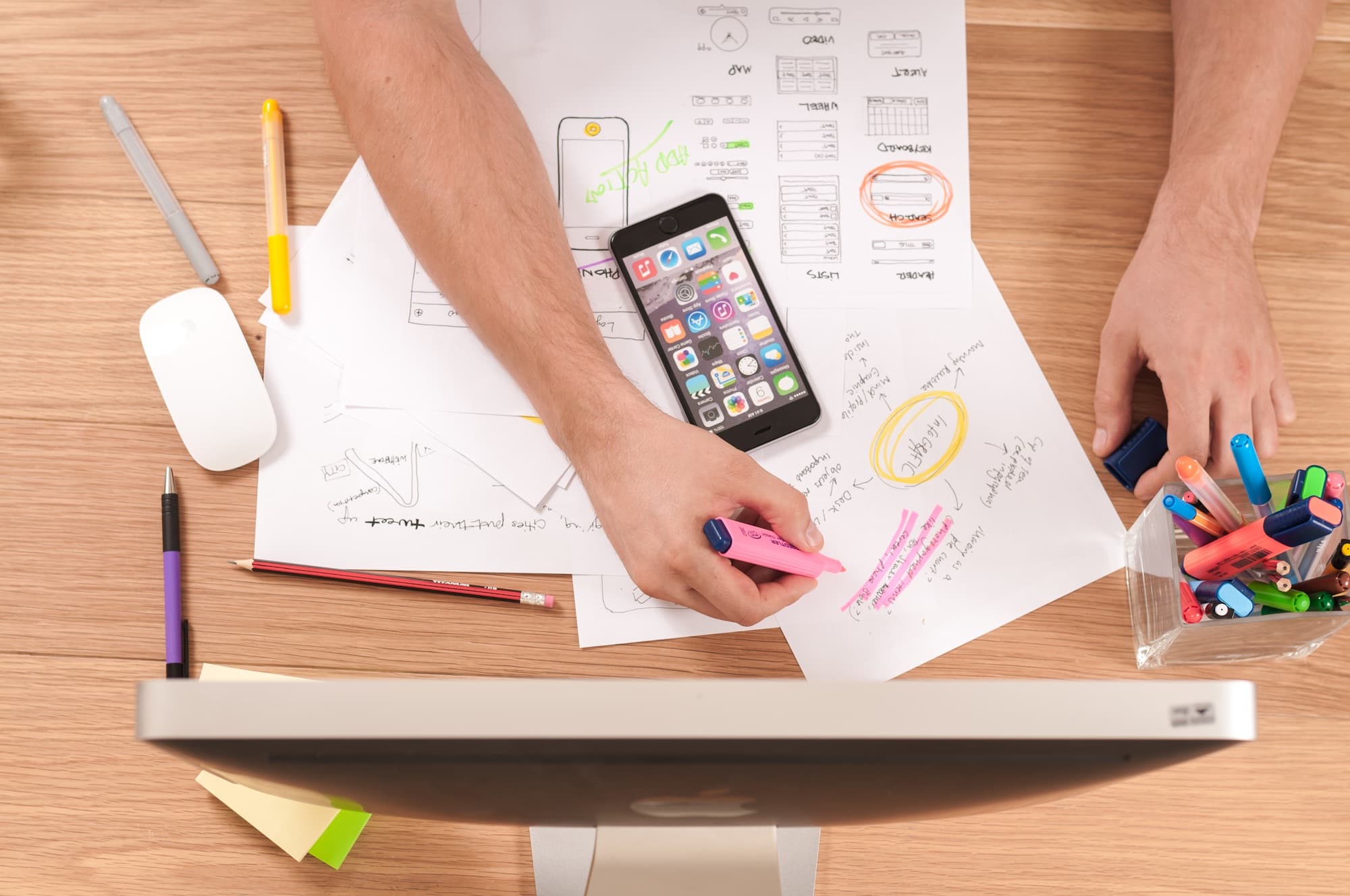 A desk of sketches and search notes — the page still has to be planned, not generated