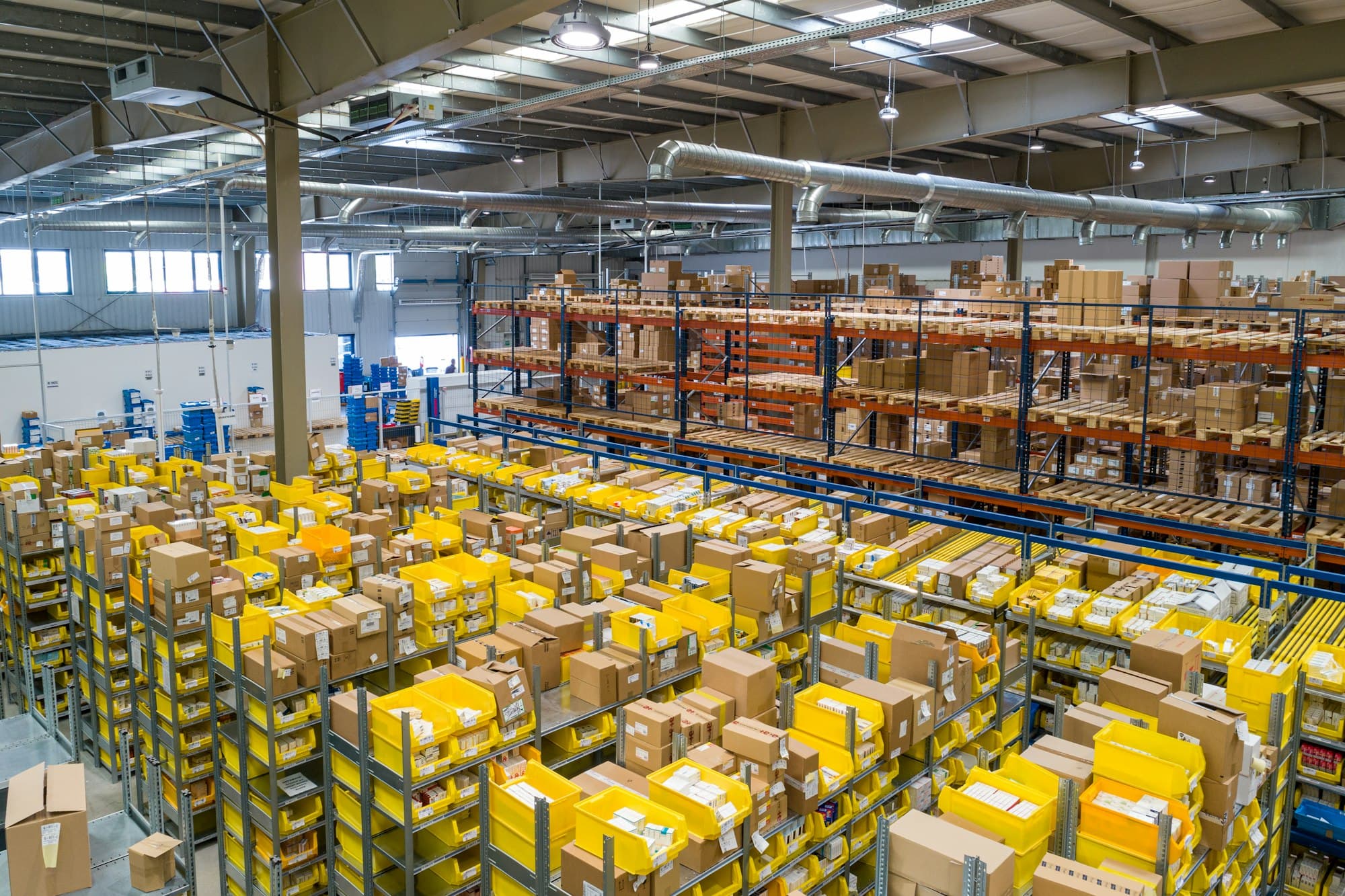 A warehouse of labeled boxes — the same goods, in rooms, on a path